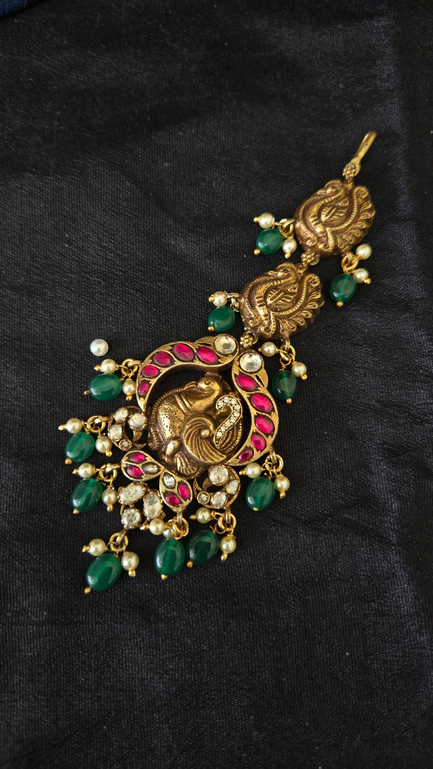 Deep Nakas Maang tikka with peacock motif