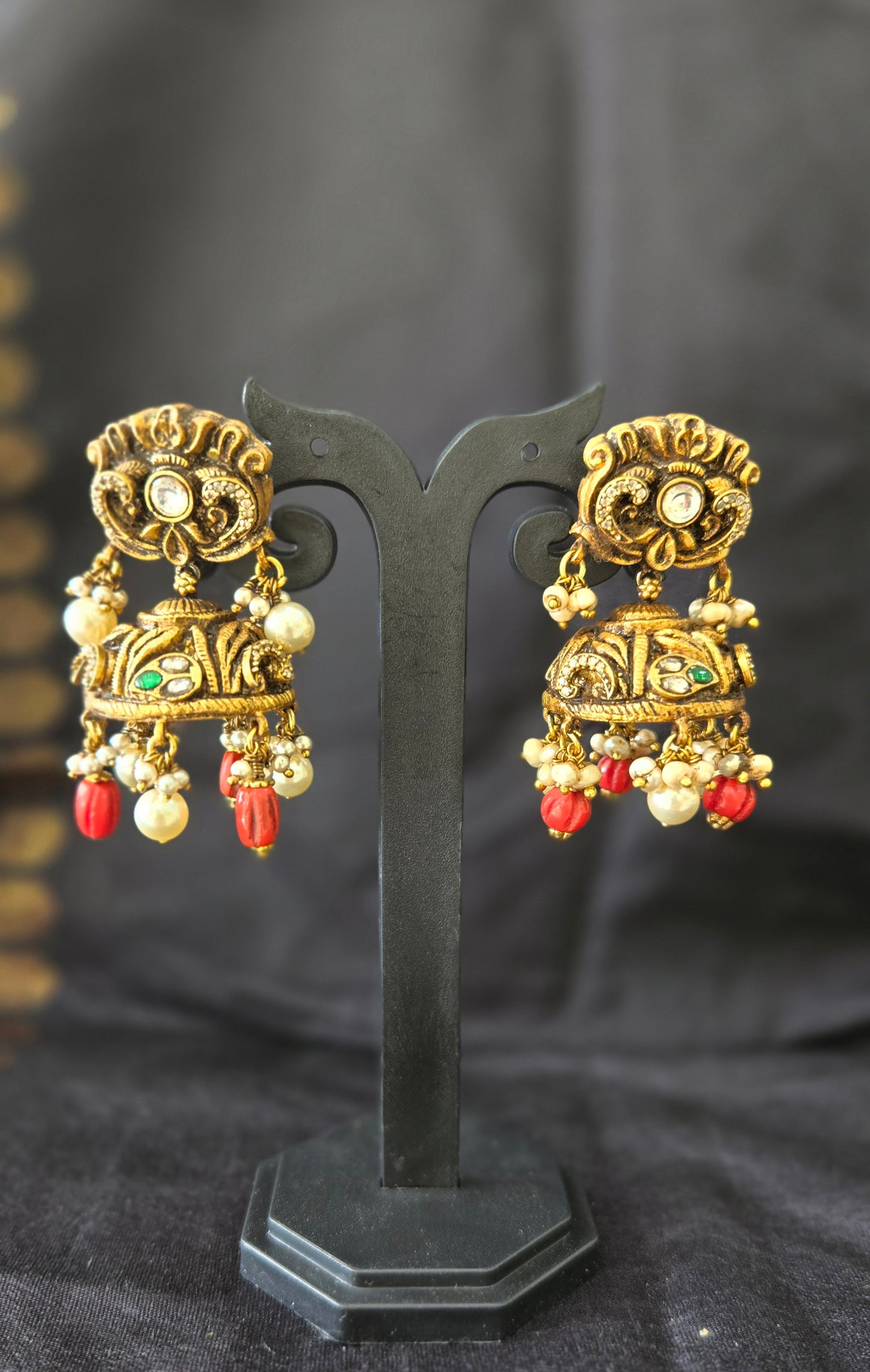 Deep Nakas with Kundan and polki studded jhumka with coral drops