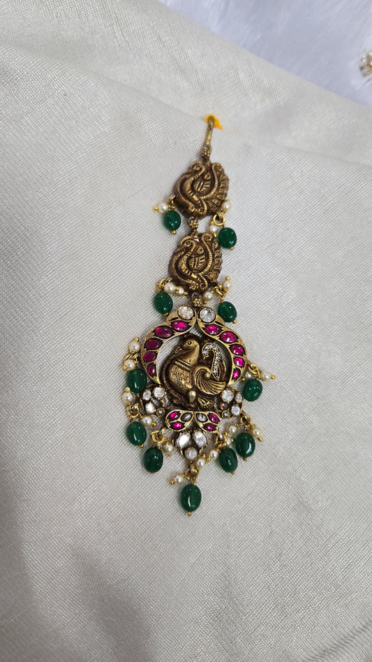 Deep Nakas Maang tikka with peacock motif