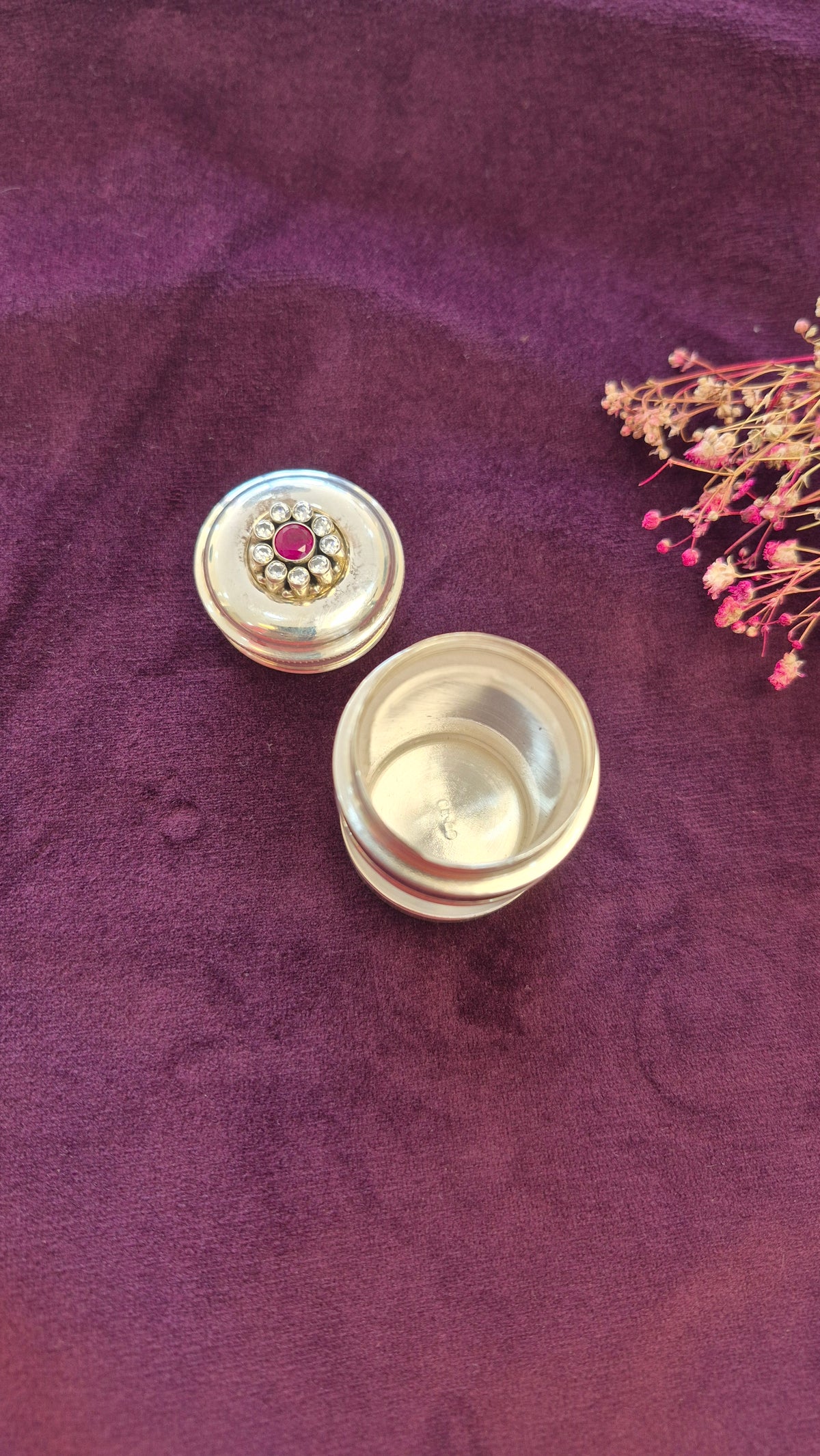 Kumkum, karpura box or multi utility silver box with red cut stone work.