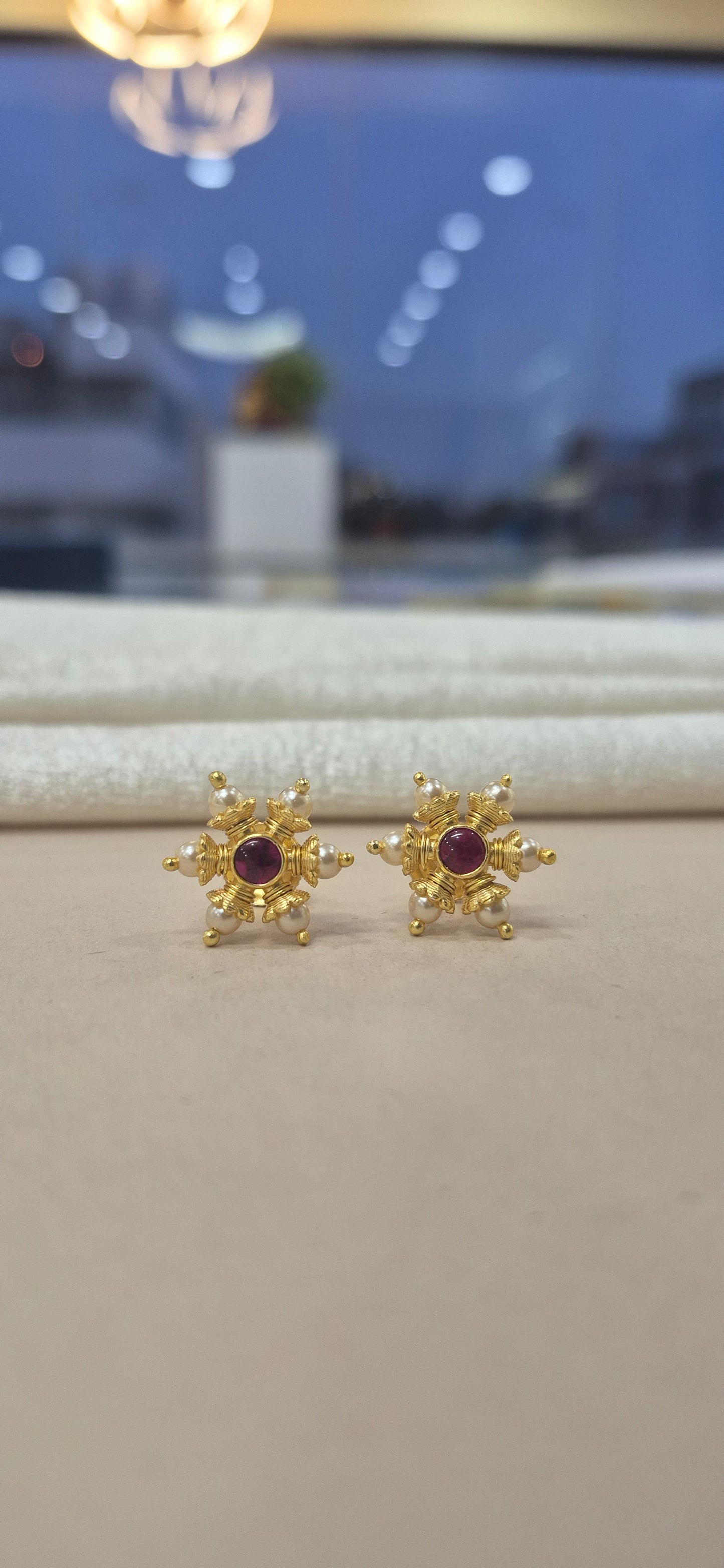 Pearl studs with red stone