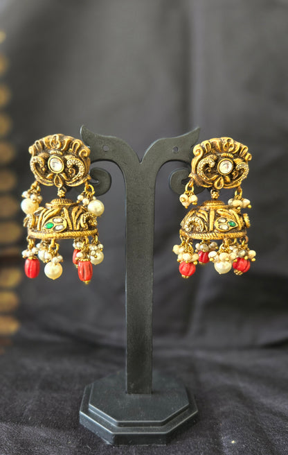 Deep Nakas with Kundan and polki studded jhumka with coral drops