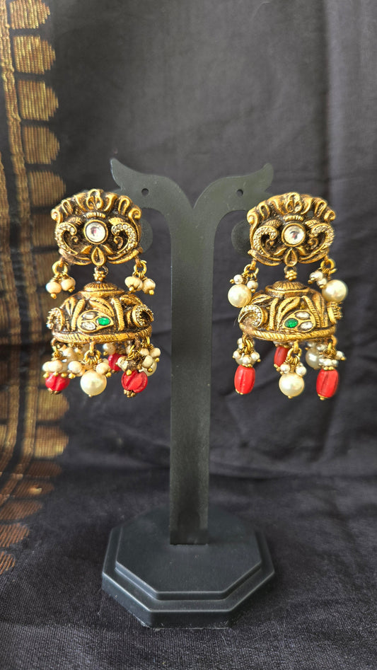 Deep Nakas with Kundan and polki studded jhumka with coral drops