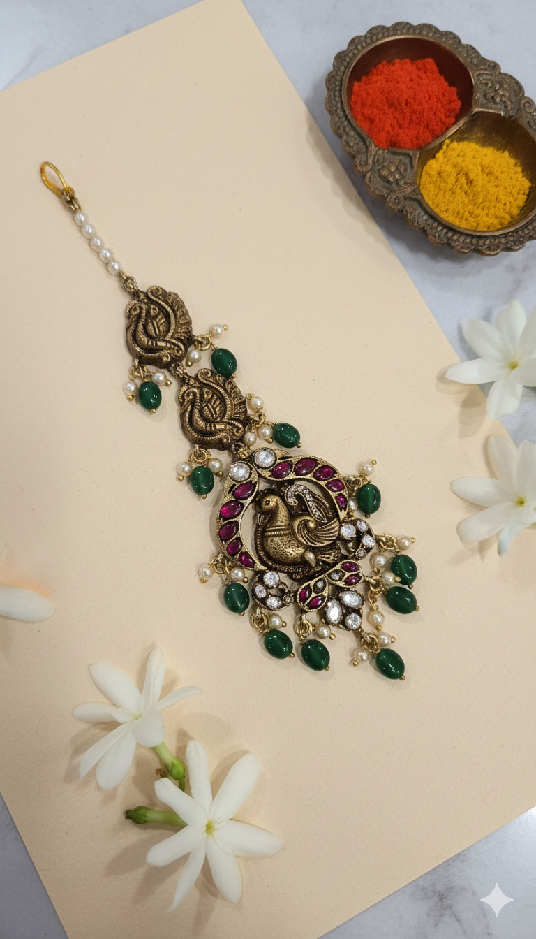 Deep Nakas Maang tikka with peacock motif