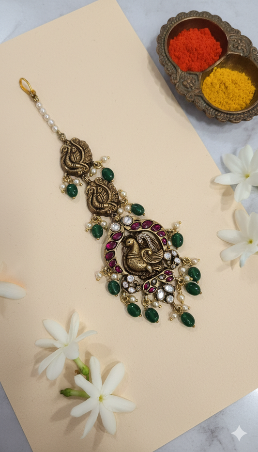 Deep Nakas Maang tikka with peacock motif